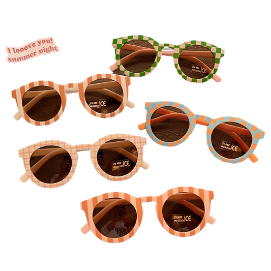 Collection of colorful sunglasses on a textured surface with a 'I loove you! summer night' sticker.