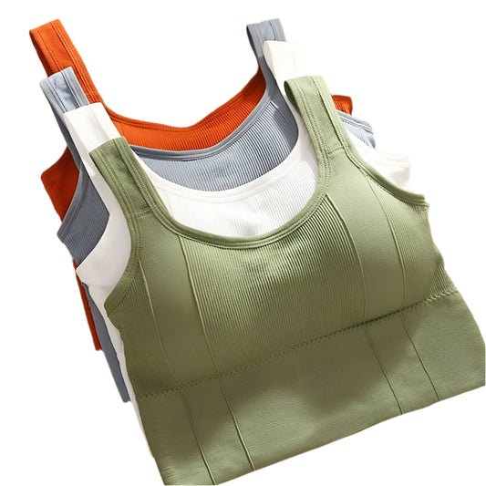 Stack of green, orange, gray, and white tank tops on a cork board background.