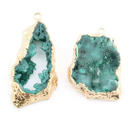 Gold-framed green geode-like earrings on a white background