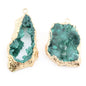 Gold-framed green geode-like earrings on a white background