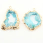 Two blue geode-style pendants with gold accents on a white background