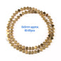 Gold beads arranged in a circular pattern on a white background with text indicating size and quantity.