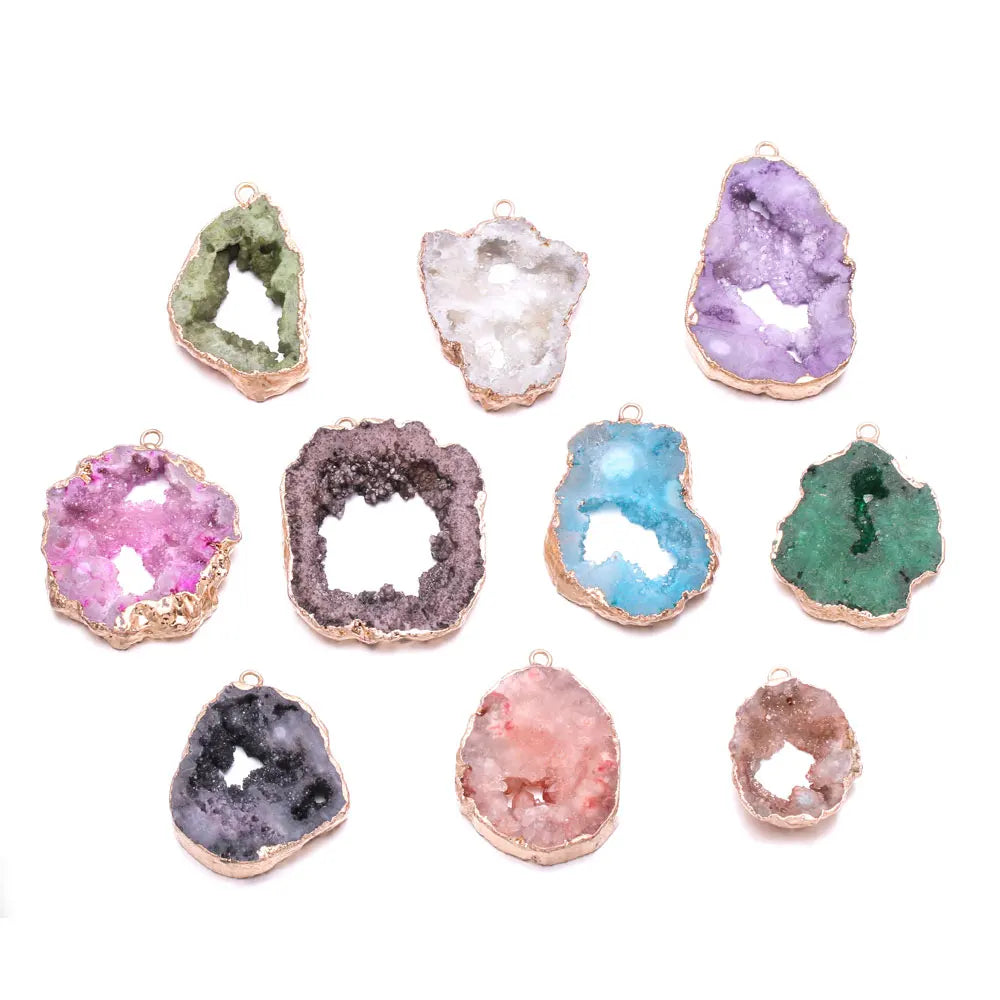 Assorted colorful crystal geode pendants on a white background