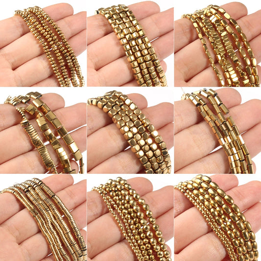 Gold beaded bracelets on a hand against a white background
