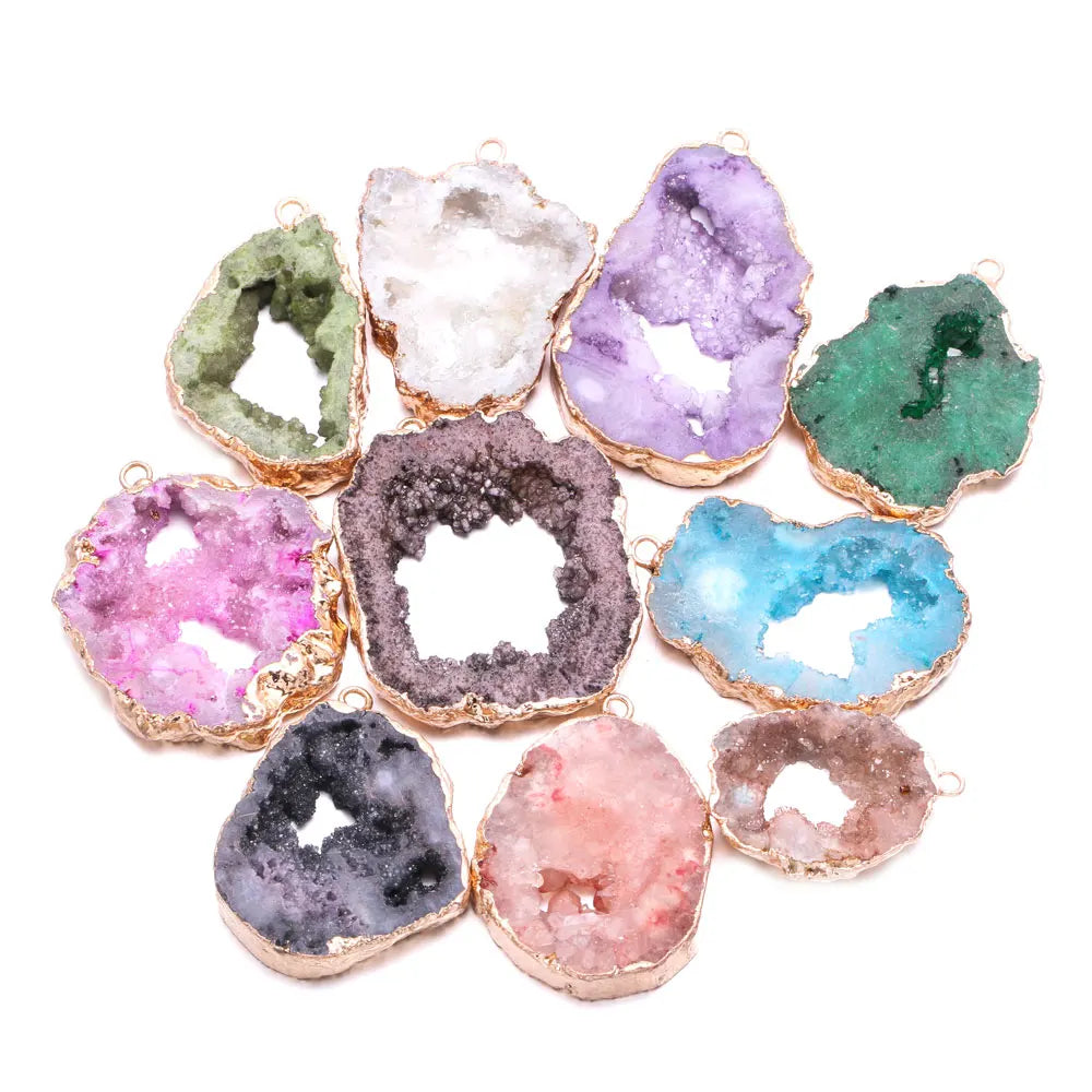Assorted colorful geode-like pendants with gold edges on a white background