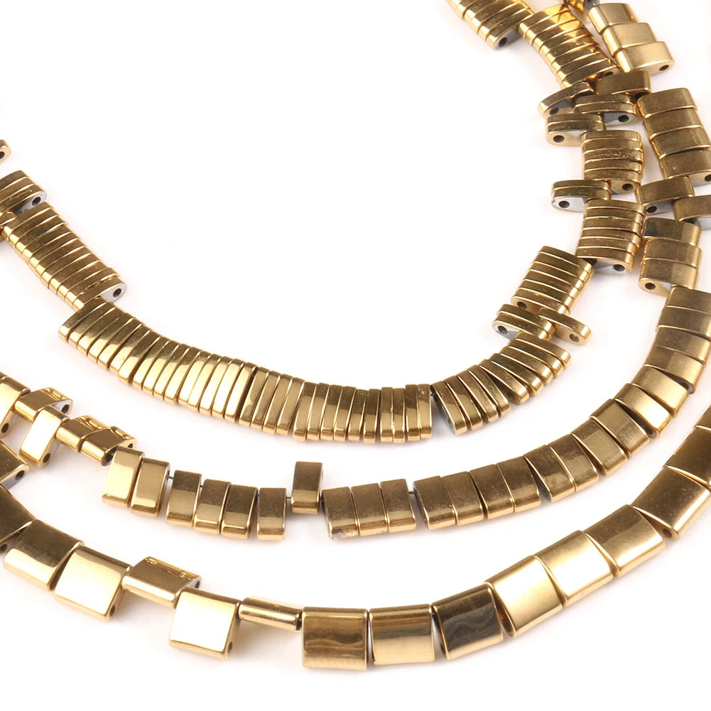 Gold necklaces with a geometric design on a white background