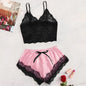Black lace top and pink satin shorts with black lace trim on a light surface.