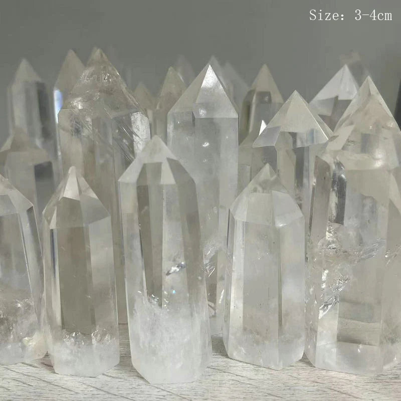 Clear crystal points on a wooden surface with a gray background