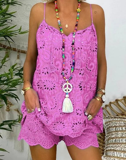 Person wearing a pink lace dress with a colorful necklace and accessories.