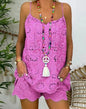 Person wearing a pink lace dress with a colorful necklace and accessories.