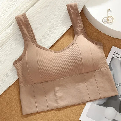 Beige tank top on a cork board with a white background