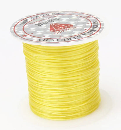 Spool of yellow thread with a brand label on a white background