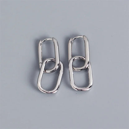 Pair of silver hoop earrings on a gray background