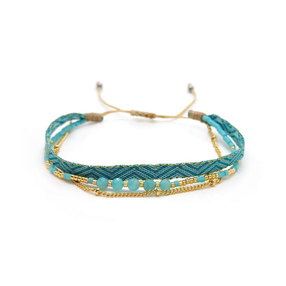 Turquoise and gold bracelet with beads on a white background