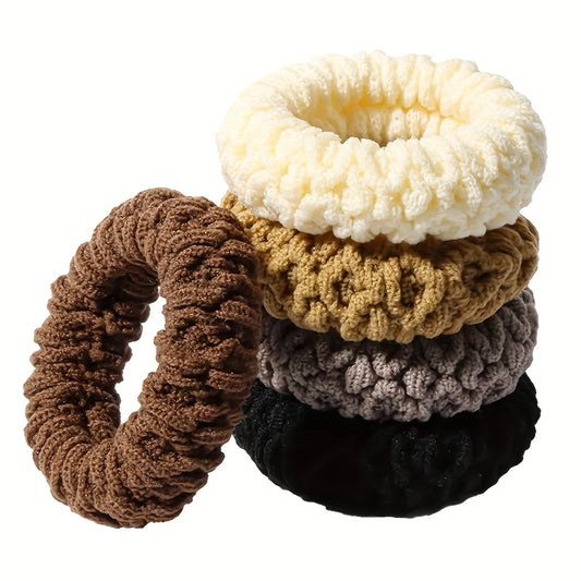 Set of five knitted scrunchies in various colors on a white background
