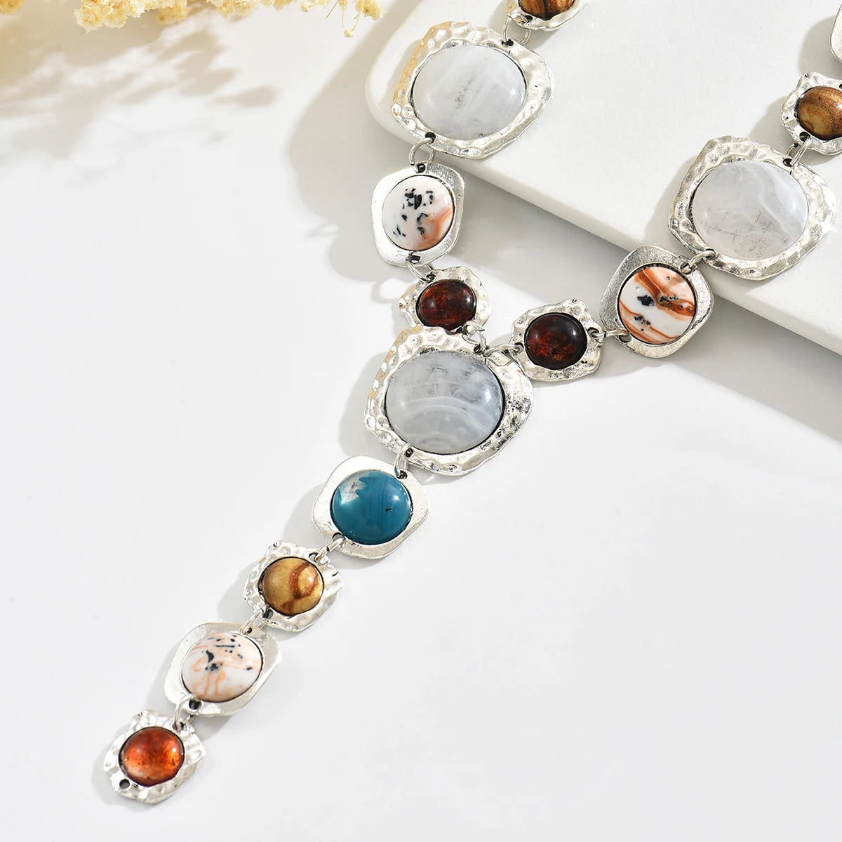 Necklace with multicolored gemstones on a white surface