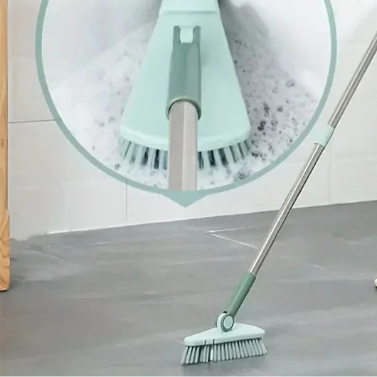 Person using a broom with a close-up of the bristle head on a tiled floor.