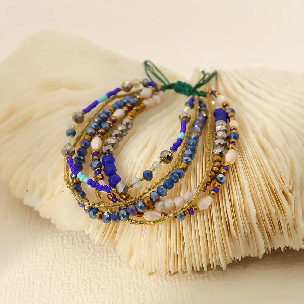Set of beaded bracelets on a textured beige surface