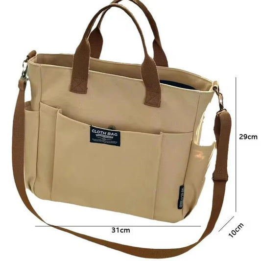 Beige tote bag with brown straps and measurements on a white background