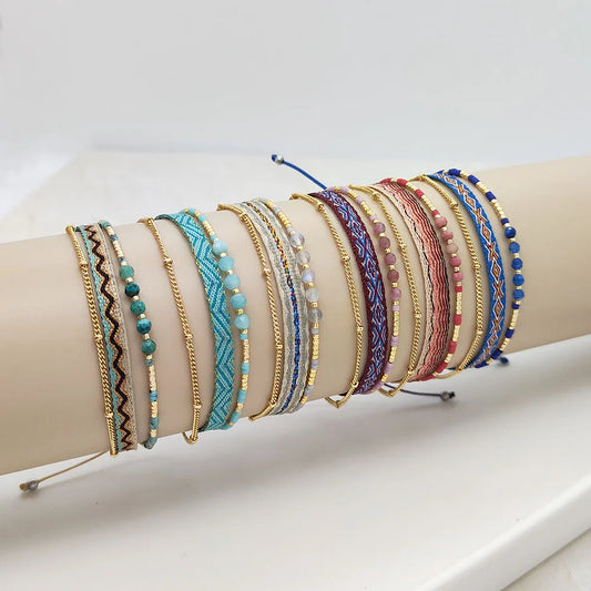 Collection of colorful bracelets on a white surface