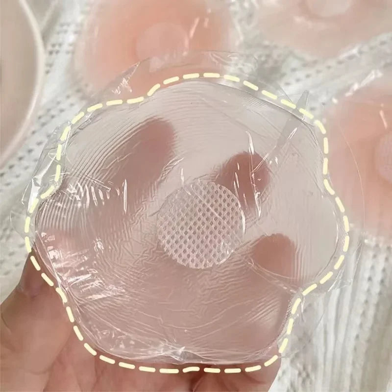 Clear plastic wrap with a textured surface held by a hand, with eggs in the background.