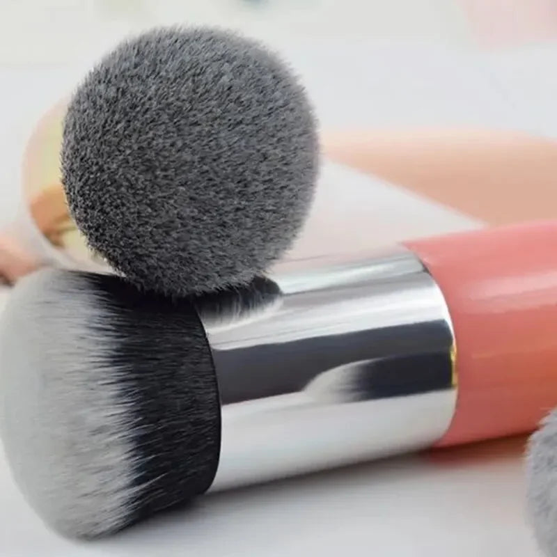 Makeup brushes with gray bristles on a light background