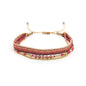 Multistrand bracelet with red and gold accents on a white background