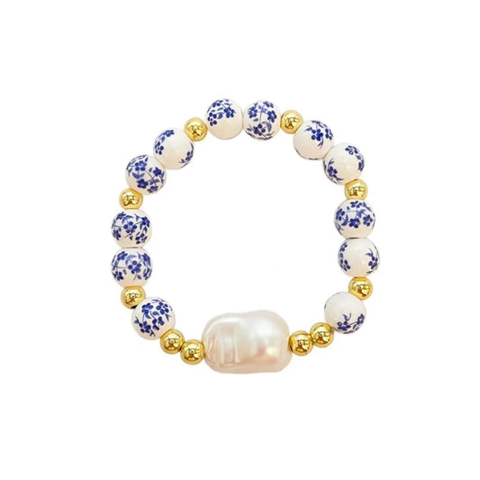 Bracelet with pearls and floral beads on a white background
