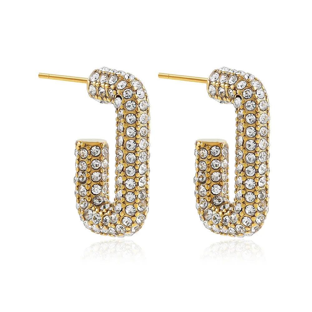 Gold hoop earrings with clear gemstones on a white background
