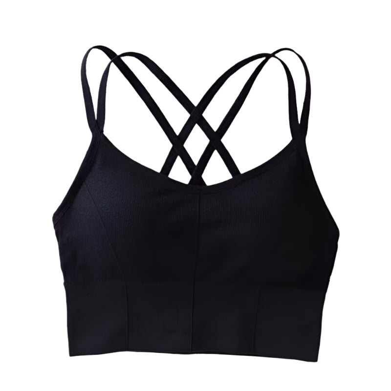 Black crop top with criss-cross straps on a white surface