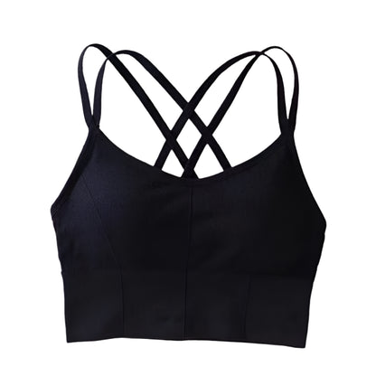 Black crop top with criss-cross straps on a white surface