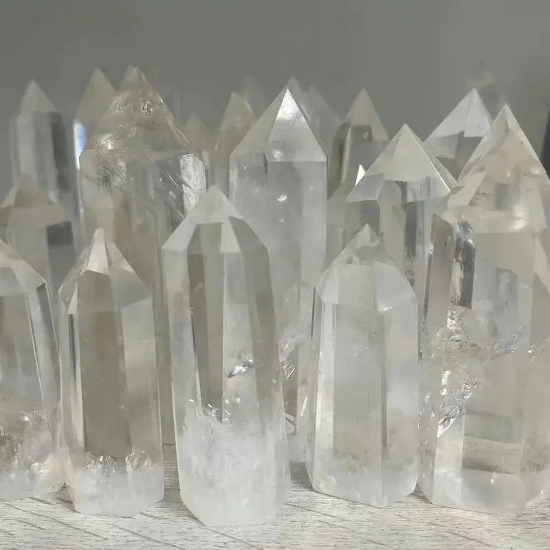 Collection of clear crystal points on a wooden surface
