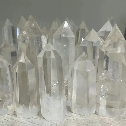Collection of clear crystal points on a wooden surface