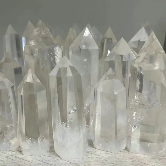 Collection of clear crystal points on a wooden surface