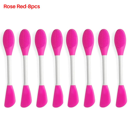 Set of eight pink silicone spoons with white handles on a white background.