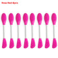 Set of eight pink silicone spoons with white handles on a white background.