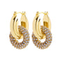 Gold hoop earrings with crystal embellishments on a white background