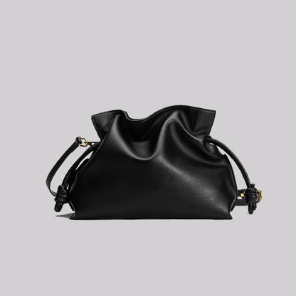Black leather drawstring bag on a light gray background