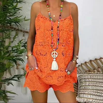 Person wearing an orange crochet romper with a colorful necklace against a neutral background