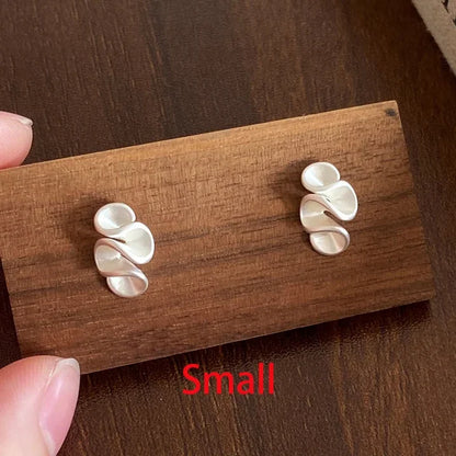 Small silver earrings on a wooden display card with 'Small' text.