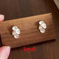 Small silver earrings on a wooden display card with 'Small' text.