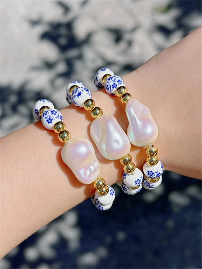 Bracelet with pearls and decorative beads on a wrist against a blurred natural background