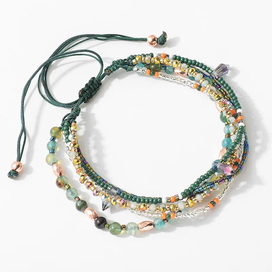 Multistrand beaded bracelet with colorful beads and metal accents on a white background