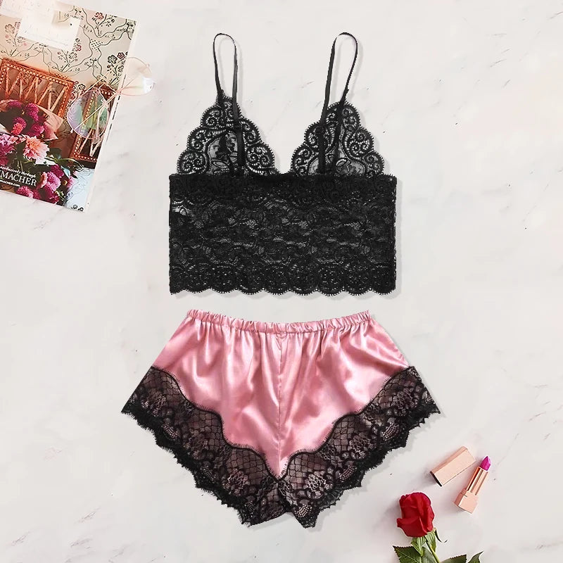 Black lace bra and pink satin shorts on a light background with a magazine and rose.