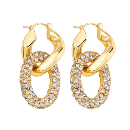 Gold hoop earrings with crystal embellishments on a white background