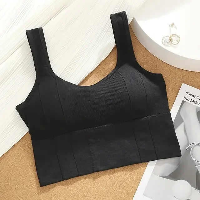 Black sports bra on a cork surface with a magazine underneath