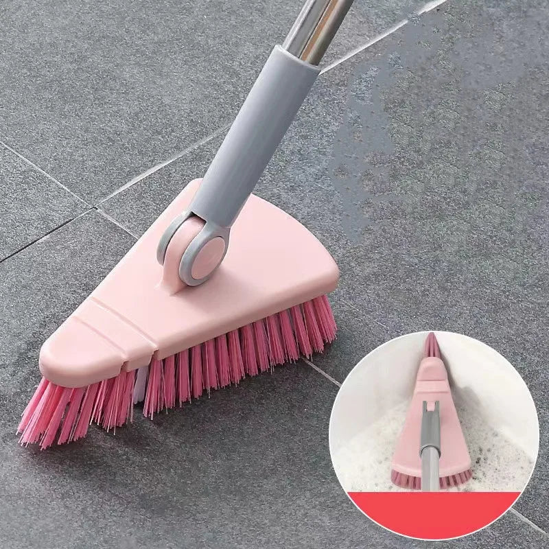 Pink cleaning brush with gray handle on a tiled floor, with an inset showing it cleaning a surface.