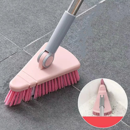 Pink cleaning brush with gray handle on a tiled floor, with an inset showing it cleaning a surface.