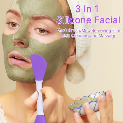 Person applying a green facial mask with a purple brush, featuring text about a 3-in-1 silicone facial mask product.