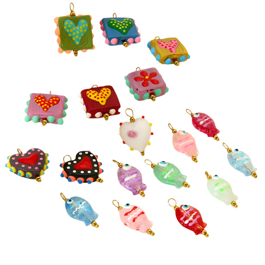 Colorful decorative charms on a white stand with a beige background